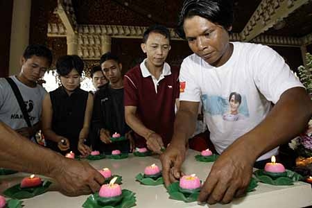 Myanmar activists light candles during a peaceful rally to show their solidarity with the democratic movement in Mynamar at Dhammikarama Burmese Buddhist Temple in Penang, Malaysia on Sunday, Oct. 14, 2007. (AP Photo/Gary Chua)