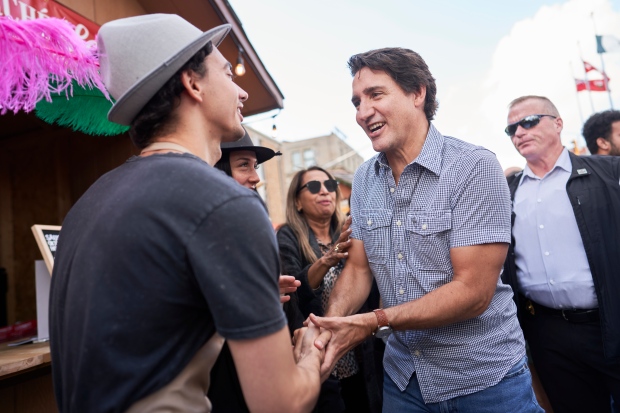 Prime Minister Justin Trudeau greets a vendor during a stop in downtown Kitchener, Ont., for the start of Oktoberfest, Friday, Oct. 6, 2023. THE CANADIAN PRESS/Geoff Robins