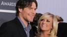 Carrie Underwood and Mike Fisher arrives at the Grammy Awards on Sunday, Jan. 31, 2010, in Los Angeles. (AP Photo/Chris Pizzello)