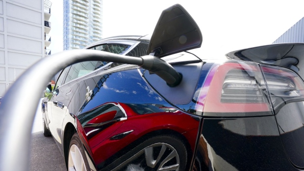 An electric vehicle is charged in Ottawa on Wednesday, July 13, 2022. The federal and Ontario governments are announcing today that they are putting nearly $1 billion combined into an electric vehicle battery component plant in eastern Ontario. THE CANADIAN PRESS/Sean Kilpatrick