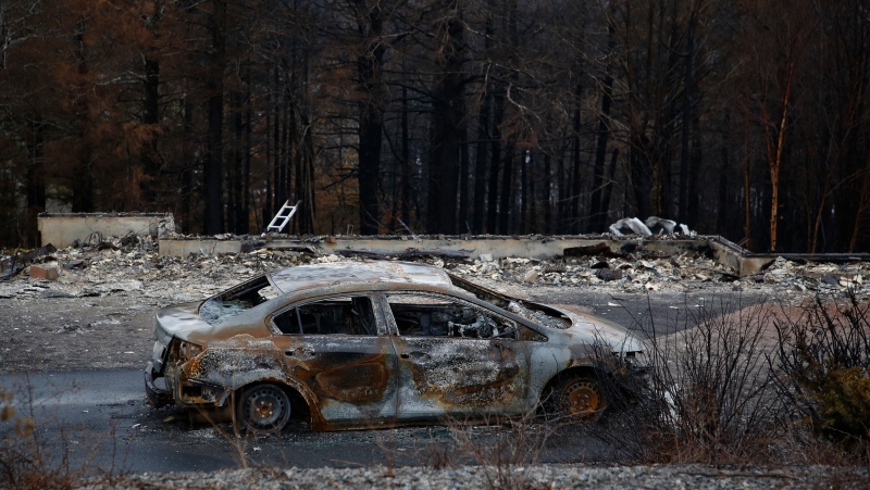 A vehicle damaged by a wildfire is seen in Hammonds Plains, N.S., during a media tour, Tuesday, June 6, 2023. THE CANADIAN PRESS/POOL, Tim Krochak