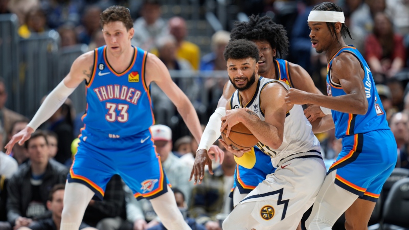 Denver Nuggets guard Jamal Murray, second from front right, looks to pass the ball as, from left to right, Oklahoma City Thunder center Mike Muscala, forward Jalen Williams and guard Shai Gilgeous-Alexander defend in the second half of an NBA basketball game Sunday, Jan. 22, 2023, in Denver. (AP Photo/David Zalubowski) 