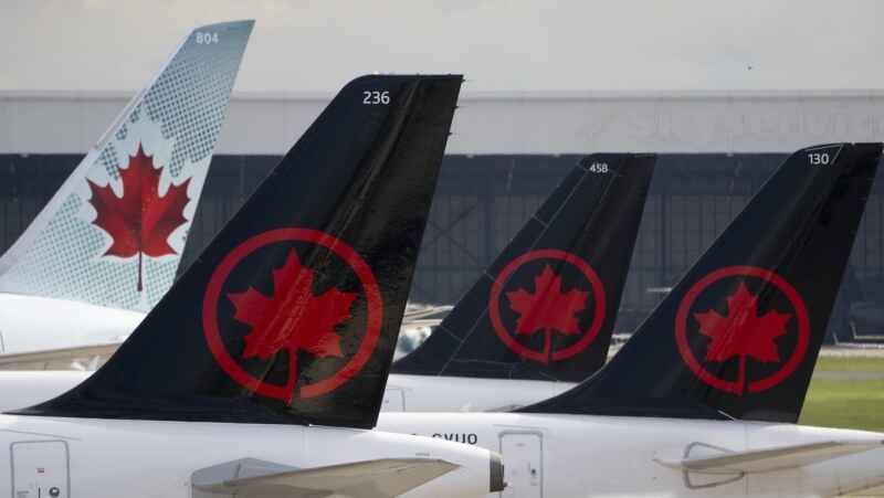 Air Canada logos are seen on the tails of planes at the airport in Montreal on Monday, June 26, 2023. . THE CANADIAN PRESS/Adrian Wyld