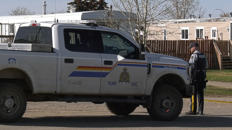(FILE) Dawson Creek RCMP officer stands next to tactical vehicle. 