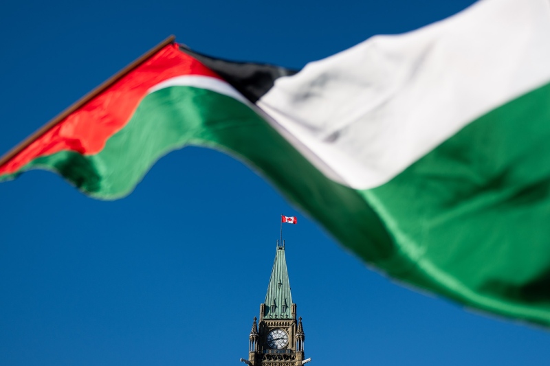 A Palestinian flag flies near the Peace Tower during a march for Gaza rally on Parliament Hill in Ottawa on Saturday, Nov. 4, 2023.  (Spencer Colby/THE CANADIAN PRESS