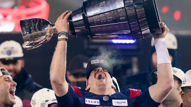 Montreal Alouettes quarterback Cody Fajardo (7) hoists the Grey Cup as the Alouettes celebrate defeating the Winnipeg Blue Bombers in the 110th CFL Grey Cup in Hamilton, Ont., on Sunday, November 19, 2023. THE CANADIAN PRESS/Frank Gunn