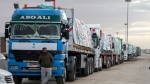 FILE- Trucks carrying humanitarian aid line up at the Rafah Border Crossing, Egypt, on the way to Gaza, Sunday, Nov. 19, 2023. (AP Photo/Amr Nabil)