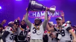 Montreal Alouettes running back William Stanback holds up the Grey Cup during the Grey Cup celebration in Montreal on Wednesday, Nov. 22, 2023. THE CANADIAN PRESS/Ryan Remiorz