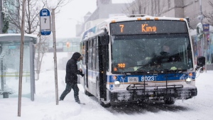 A rider boards a Grand River Transit bus on a snowy day in downtown Kitchener. (Source: Grand River Transit)