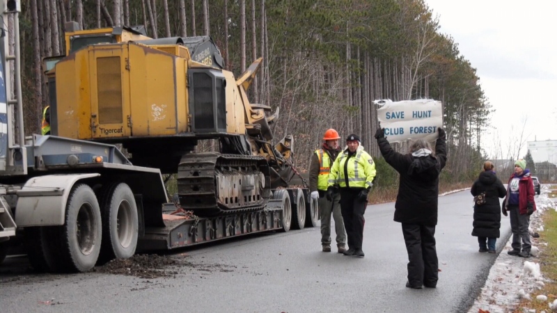 Demonstrators gathered on Monday morning as workers began clearing a section of forest on Hunt Club Road. (Jackie Perez/CTV News Ottawa)