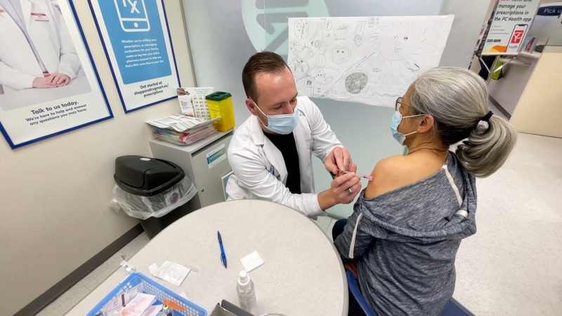 Rosie Tay getting her COVID-19 vaccine from Pharmacist Jordan Clark. (Dave Charbonneau/CTV News Ottawa)