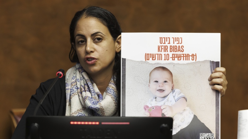 Ofri Bibas Levy, sister of Yarden Bibas, held hostage in Gaza with his wife, Shiri and two kids, Kfir and Ariel, talks to the media, during a press conference at the European headquarters of the United Nations in Geneva, Switzerland, on Nov. 14, 2023. (Salvatore Di Nolfi/Keystone via AP, File)