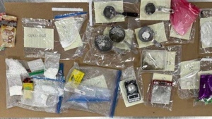 Calgary police display the items and drugs found during the search of a home in the 2600 block of Erlton Street S.W., on Nov. 23, 2023. (Calgary Police Service handout) 