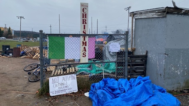 Signage at the gated at the Lower Sackville, N.S., homeless encampment on Cobequid Road on Nov. 28, 2023. The ballfield was saturated with water from a storm and about 10 tents collapsed. (Bruce Frisko/CTV News Atlantic)