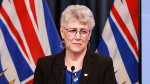 FILE: Minister of Finance Katrine Conroy looks on as she answers questions from reporters following an update about the province's 2022-23 public accounts during a press conference in the press theatre at the legislature in Victoria, B.C., on Aug. 30, 2023. THE CANADIAN PRESS/Chad Hipolito