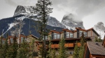 The Three Sisters loom over homes in Canmore, Alta., Monday, April 24, 2023. (THE CANADIAN PRESS/Jeff McIntosh)