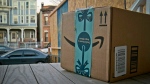 FILE: This image taken from video shows an Amazon package containing a GPS tracker on the porch of a Jersey City, N.J. residence after its delivery Tuesday, Dec. 11, 2018. The explosion in online shopping has led to porch pirates and stoop surfers swiping holiday packages from unsuspecting residents. AP Photo/Robert Bumsted