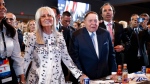 Las Vegas Sands Corporation Chief Executive and Republican mega donor Sheldon Adelson, center, and his wife, Miriam Adelson, left, listen as President Donald Trump speaks at the Israeli American Council National Summit in Hollywood, Fla., Saturday, Dec. 7, 2019. Miriam Adelson, the controlling shareholder of casino company Las Vegas Sands Corp., plans to sell US$2 billion in company stock and buy an unspecified professional sports franchise, the company announced Tuesday, Nov. 28, 2023. Dallas Mavericks owner Mark Cuban is working on a deal to sell a majority stake in the NBA franchise to the Adelson family, a person with knowledge of the talks said late Tuesday. (AP Photo/Patrick Semansky, File)