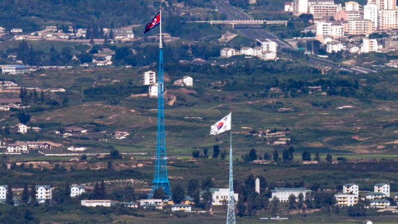 Flags of North Korea, rear, and South Korea, front, flutter in the wind as pictured from the border area between two Koreas in Paju, South Korea, on Aug. 9, 2021. South Korea says it has postponed the planned launch of its first military spy satellite set for this Thursday, Nov. 30. South Korea's first domestically built spy satellite had been scheduled to lift off aboard SpaceX’s Falcon 9 rocket from California’s Vandenberg Air Force Base.(Im Byung-shik/Yonhap via AP, File)