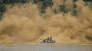 South Korea's K21 infantry fighting vehicle sails to shores in a smoke during the combined wet gap crossing military drill between South Korea and the United States as a part of the Ulchi Freedom Shield military exercise in Cheorwon, South Korea, on Aug. 31, 2023. (AP Photo/Lee Jin-man)