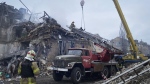 In this photo provided by the Ukrainian Emergency Service, rescuers work at the scene of a building damaged by shelling, in Novogrodivka, Ukraine, Thursday, Nov. 30, 2023. (Ukrainian Emergency Service via AP)