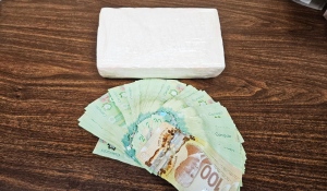 Ontario Provincial Police stopped the vehicles just before 11 p.m. and arrested three people. They also found a one-kilogram brick of cocaine and $3,000 in cash. (OPP photo)