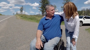 Rick Hansen and Sandie Rinaldo chat near the side of the road at the place where his life changed irrevocably.