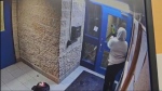 Security video appears to show a woman setting a fire and smashing windows with an axe. 