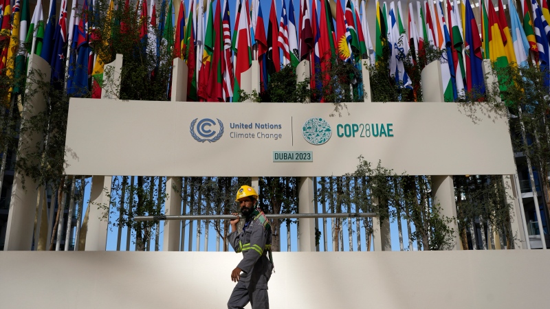 A worker sets up at the COP28 U.N. Climate Summit, Thursday, Nov. 30, 2023, in Dubai, United Arab Emirates. (AP Photo/Rafiq Maqbool)