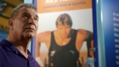 In this picture, Rick Hansen is looking at a museum exhibit on his life and tour across the world. 