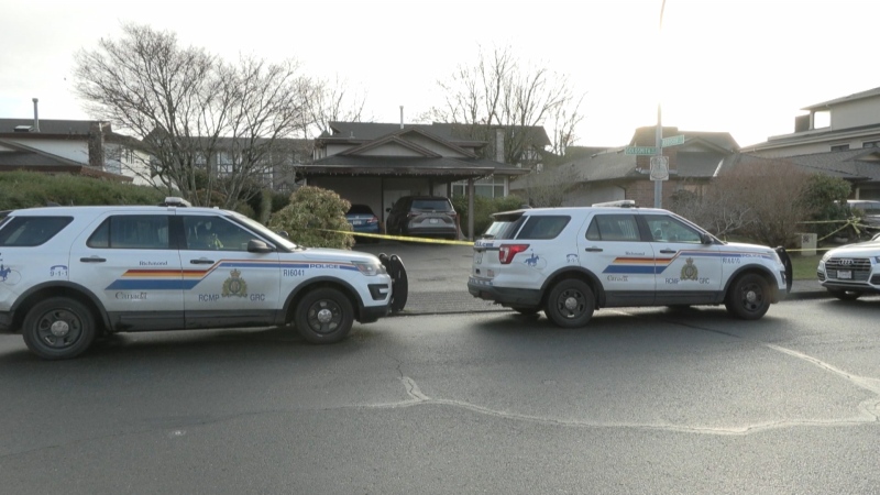 RCMP vehicles and police tape are seen outside a home on Goldsmith Drive in Richmond after two bodies were discovered inside. (CTV)