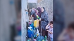 Nabila Manna filling water in a jug in Gaza during the harrowing 40 days. (Courtesy: Nabila Manna)