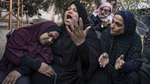 Palestinians mourn their relatives killed in the Israeli bombardment of the Gaza Strip, in the hospital in Khan Younis, Saturday, Dec. 2, 2023. (AP Photo/Fatima Shbair)
