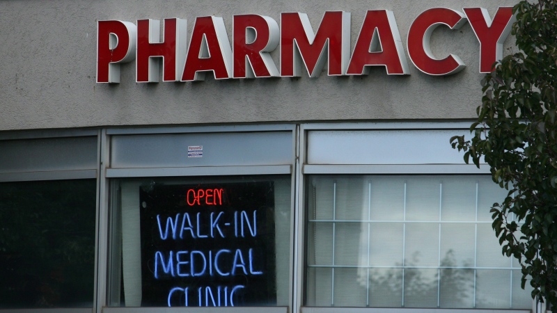 A sign for a pharmacy and walk-in health clinic shown in Oakville, Ont., Thursday, Oct.13, 2016. THE CANADIAN PRESS IMAGES/Richard Buchan