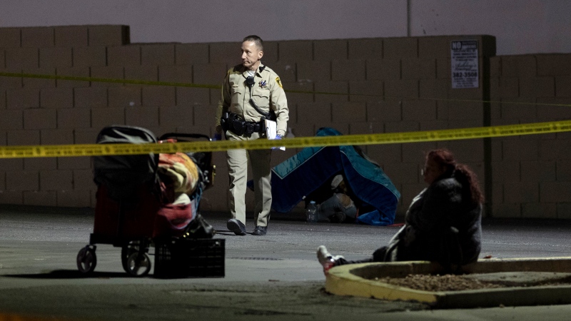 Metropolitan police investigate the scene of a shooting on Friday, Dec. 1, 2023, in Las Vegas. Five homeless people were shot, Friday, one of them fatally, and police were searching for a lone suspect, authorities said. (Ellen Schmidt /Las Vegas Review-Journal via AP)