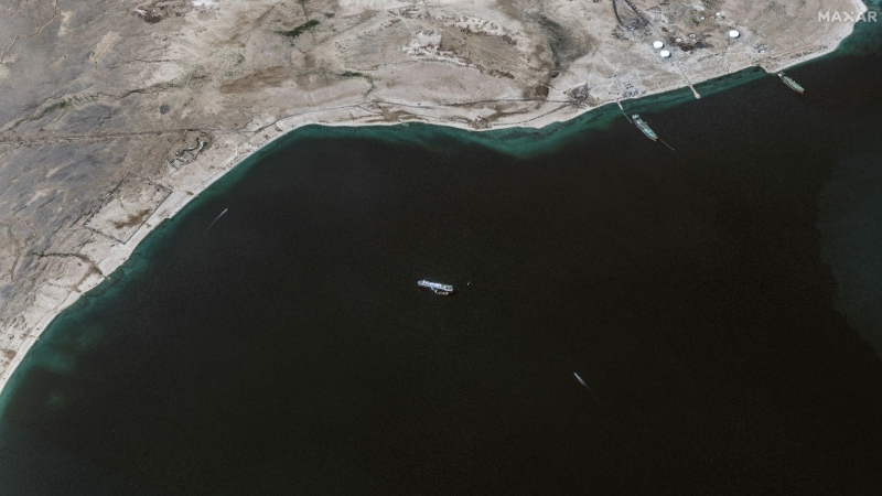 This satellite image provided by Maxar Technologies shows a ship anchored offshore of As Salif, Yemen, in the Red Sea, on Tuesday, Nov. 28, 2023. An American warship and multiple commercial ships came under attack Sunday in the Red Sea, the Pentagon said. (Satellite image ©2023 Maxar Technologies via AP)