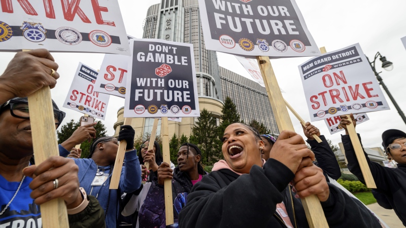 Prep cook Lakishia Williams, right, joins hundreds of unionized workers to walk the picket line during a strike in front of the MGM Grand Detroit casino, in Detroit, Tuesday, Oct. 17, 2023. (David Guralnick/Detroit News via AP)