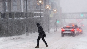 A pedestrian crosses a street in Halifax on Monday, Dec. 12, 2016. (THE CANADIAN PRESS/Andrew Vaughan)