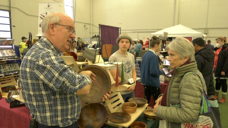 Jonathan Crone shows his woodworking creations at the 613Christmas Market, presented by 613flea at Carleton University on Sunday, Dec. 3, 2023 (Katelyn Wilson/CTV News).