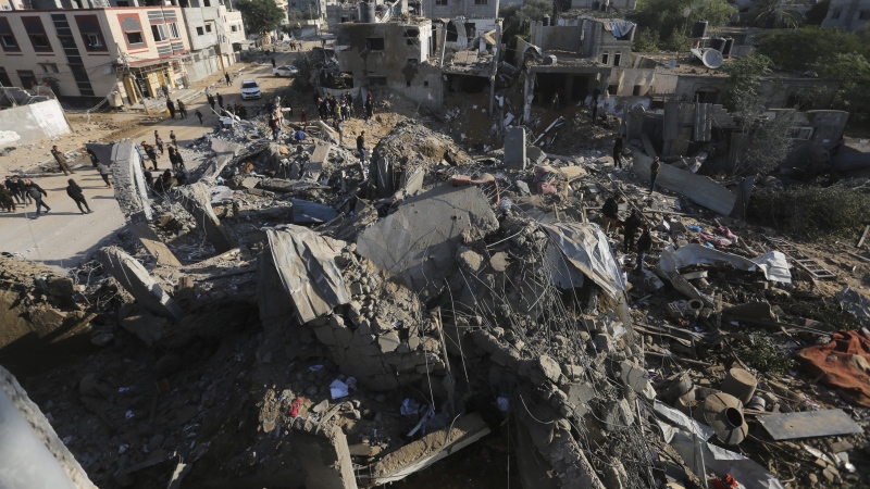 Palestinians look at the destruction by the Israeli bombardment of the Gaza Strip in Rafah, Monday, Dec. 4, 2023. (AP Photo/Hatem Ali)