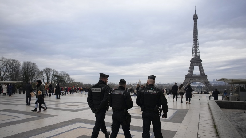 French gendarmes patrol the Trocadero plaza near the Eiffel Tower Sunday, Dec. 3, 2023 after a man targeted passersby late Saturday, killing a German tourist with a knife and injuring two others in Paris. (AP Photo/Christophe Ena)