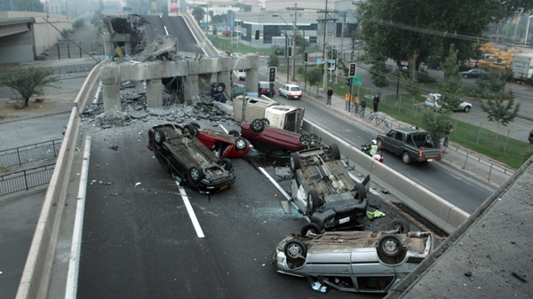 Vehicles that were driving along a highway that collapsed during the earthquake near Santiago are seen overturned on the asphalt Saturday, Feb. 27, 2010. (AP / David Lillo)