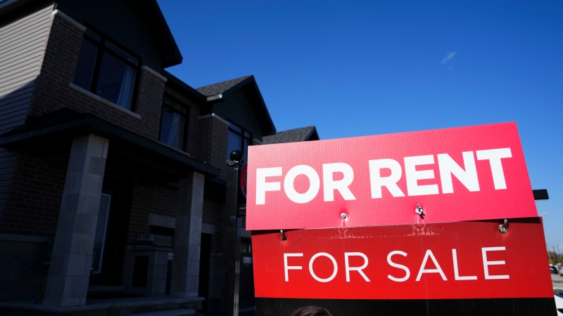 A for rent and a for sale sign are displayed on a house in a new housing development in Ottawa on Friday, Oct. 14, 2022. 
