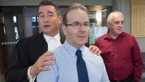 Glen Assoun, the Nova Scotia man who spent almost 17 years in prison for a crime he didn't commit, his lawyer Sean MacDonald and Ron Dalton, right, from the advocacy group Innocence Canada, stand outside Supreme Court in Halifax on July 12, 2019. (THE CANADIAN PRESS/Andrew Vaughan)