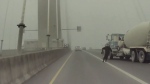 Shocking video is circulating online showing a man nearly being struck by a truck on the Port Mann Bridge during a period of heavy fog.