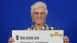 Beverley Chapple of Midland, Ont., holds her big cheque after winning the Instant Crossword Game #3236. (Source: OLG)