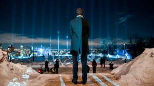 Prime Minister Justin Trudeau looks on as fourteen beams of light are projected into the sky following a vigil to honour the victims of the 1989 Polytechnique massacre in Montreal, Wednesday, December 6, 2023. Today marks the 34th anniversary of the shooting rampage that left 14 women dead. THE CANADIAN PRESS/Graham Hughes