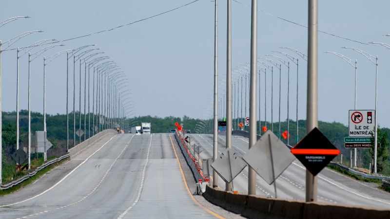 FILE: The approach to the Ile-aux-Tourtes bridge on Highway 40 is seen empty of traffic after being closed, in Montreal, Friday, May 21, 2021. THE CANADIAN PRESS/Peter McCabe