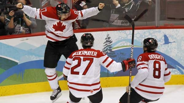 Canada's Sidney Crosby celebrates his game winning goal with Scott Niedermayer and Drew Doughty during overtime period men's ice hockey gold medal final at the 2010 Winter Olympic Games in Vancouver, Sunday, Feb. 28, 2010. THE CANADIAN PRESS/Paul Chiasson