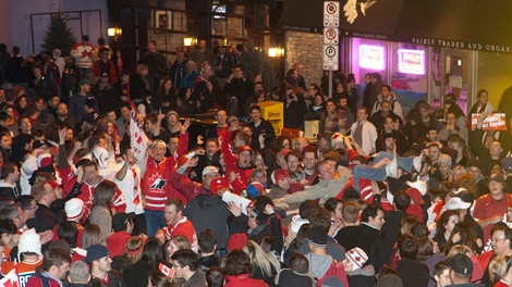 A crowd of celebratory Team Canada hockey fans blocks traffic on Elgin Street in Ottawa following Team Canada's overtime win to take gold in men's hockey at the 2010 Vancouver winter Olympics on Sunday, Feb. 28, 2010. THE CANADIAN PRESS/Pawel Dwulit